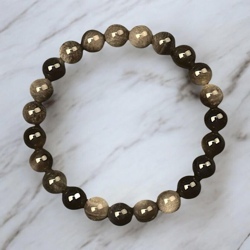 Gold-Obsidian Kugelarmband – schützende Kraft in tiefem Schwarz mit goldenem Schimmer