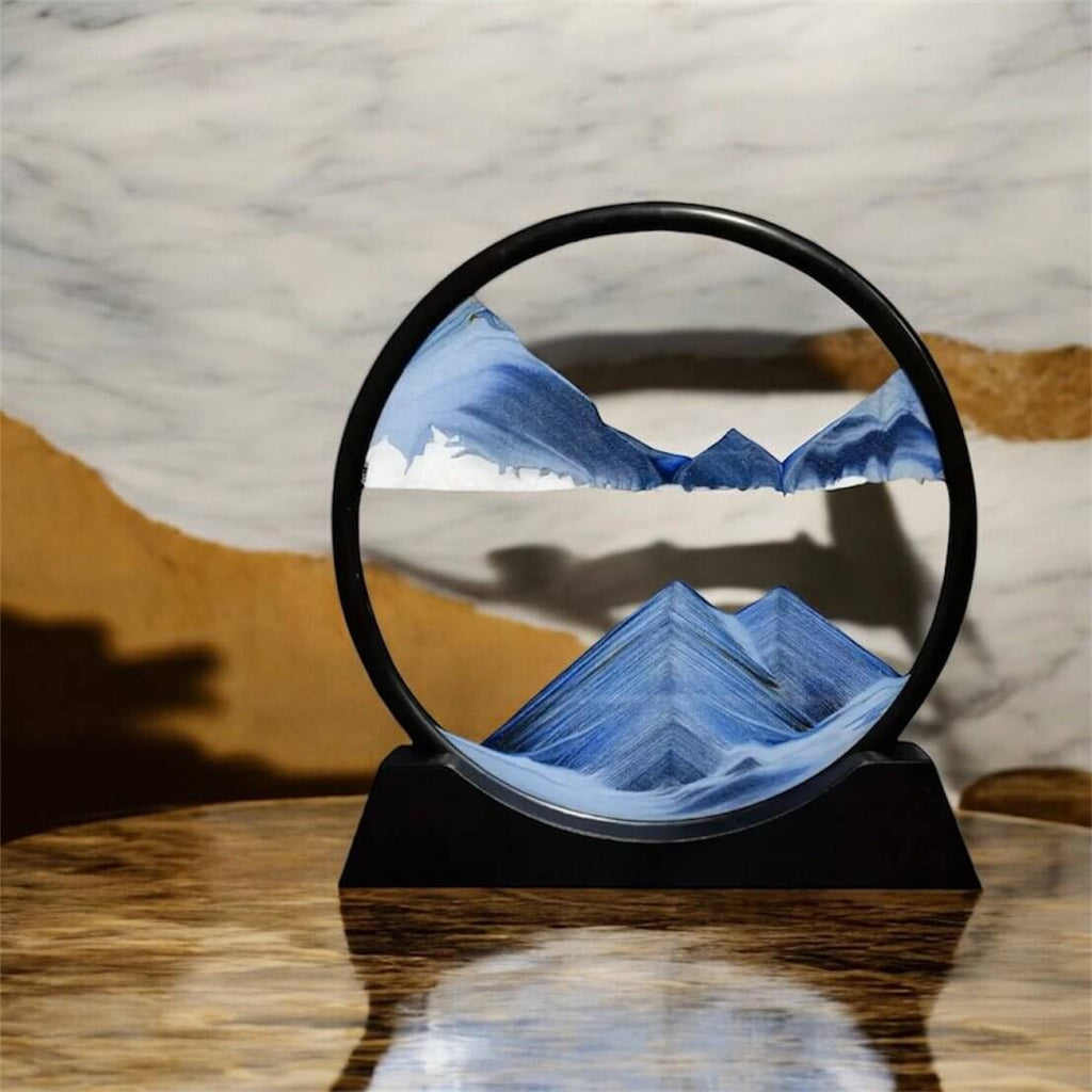 Sandbild in rundem schwarzen Rahmen Blau