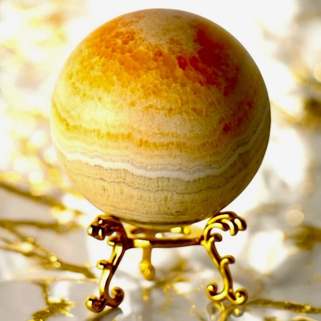Strahlende Calcit Kugel in Orange – Symbol für Lebensfreude und Kreativität